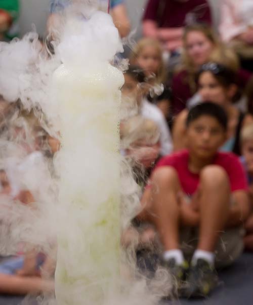 A beaker smokes and fumes at the Texas A&M University Chemistry Road Show.