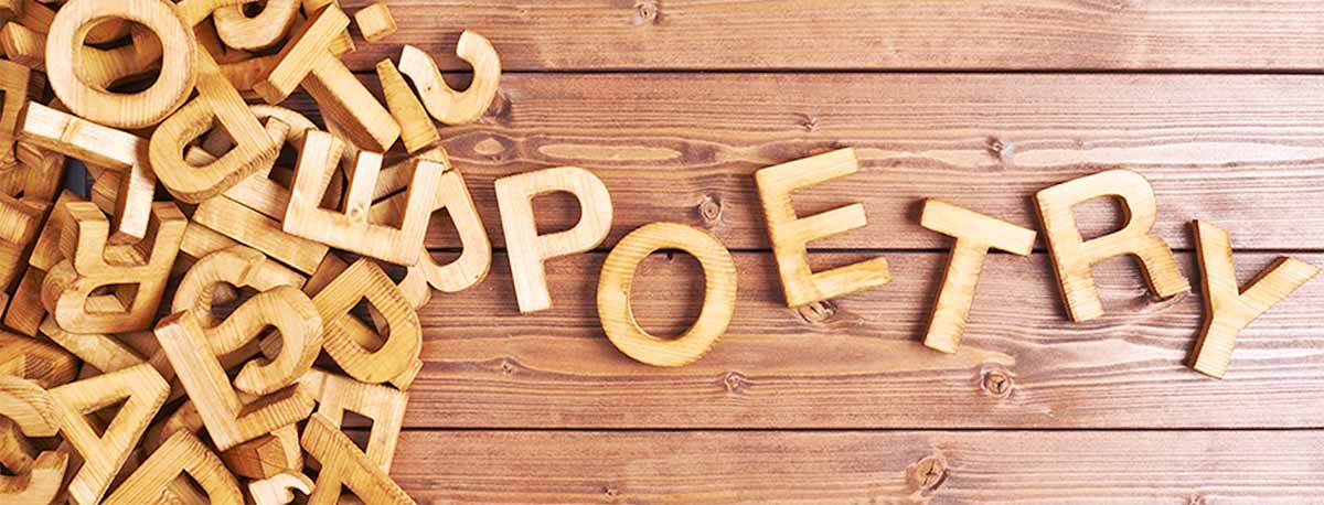 image of wooden letter cutouts and they are arranged to spell the word "poetry."