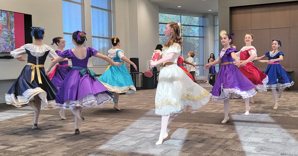 group of ballerinas in costume dancing The Nutcracker performance