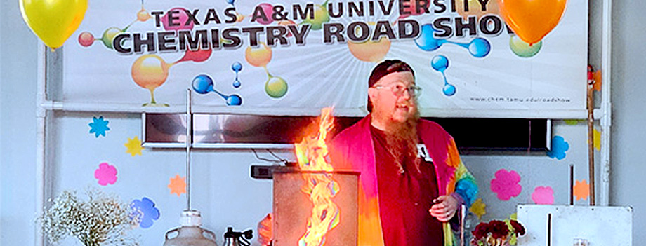 presenter demonstrating a chemistry expriment with a controlled flame