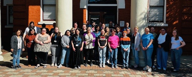 Group photo of library staff in front of the Carnegie History Center.
