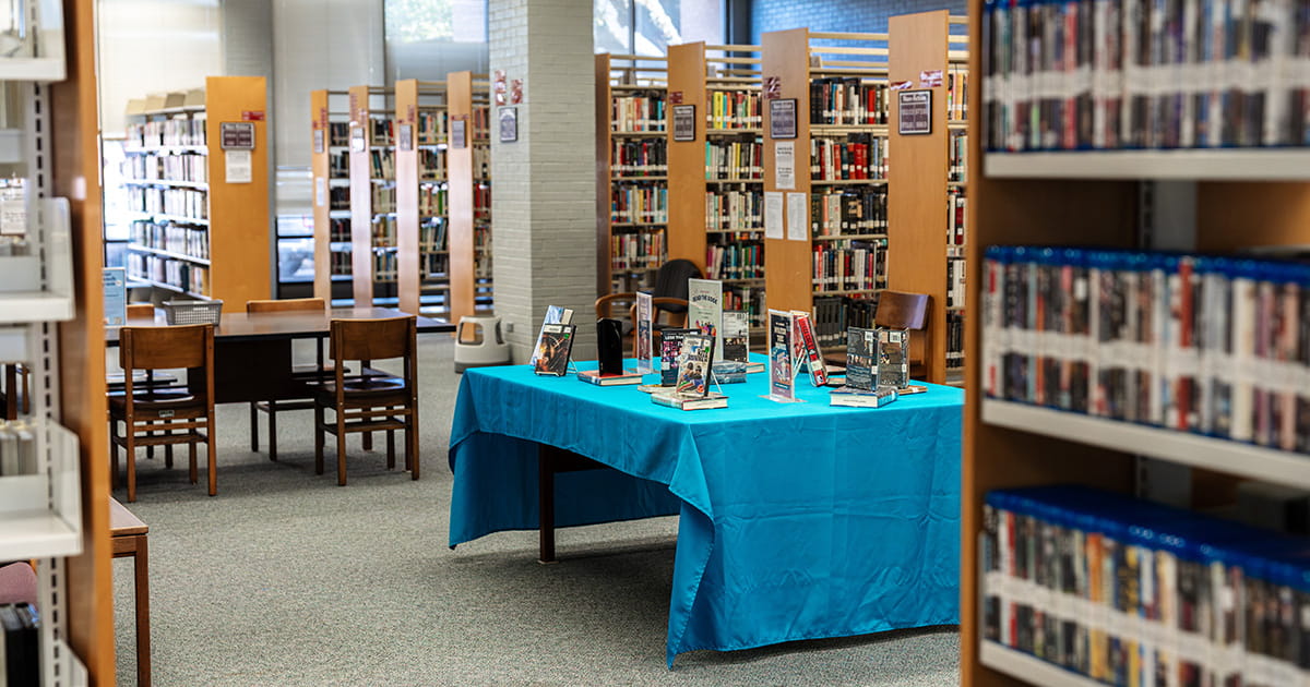 book table and shelves within a public library